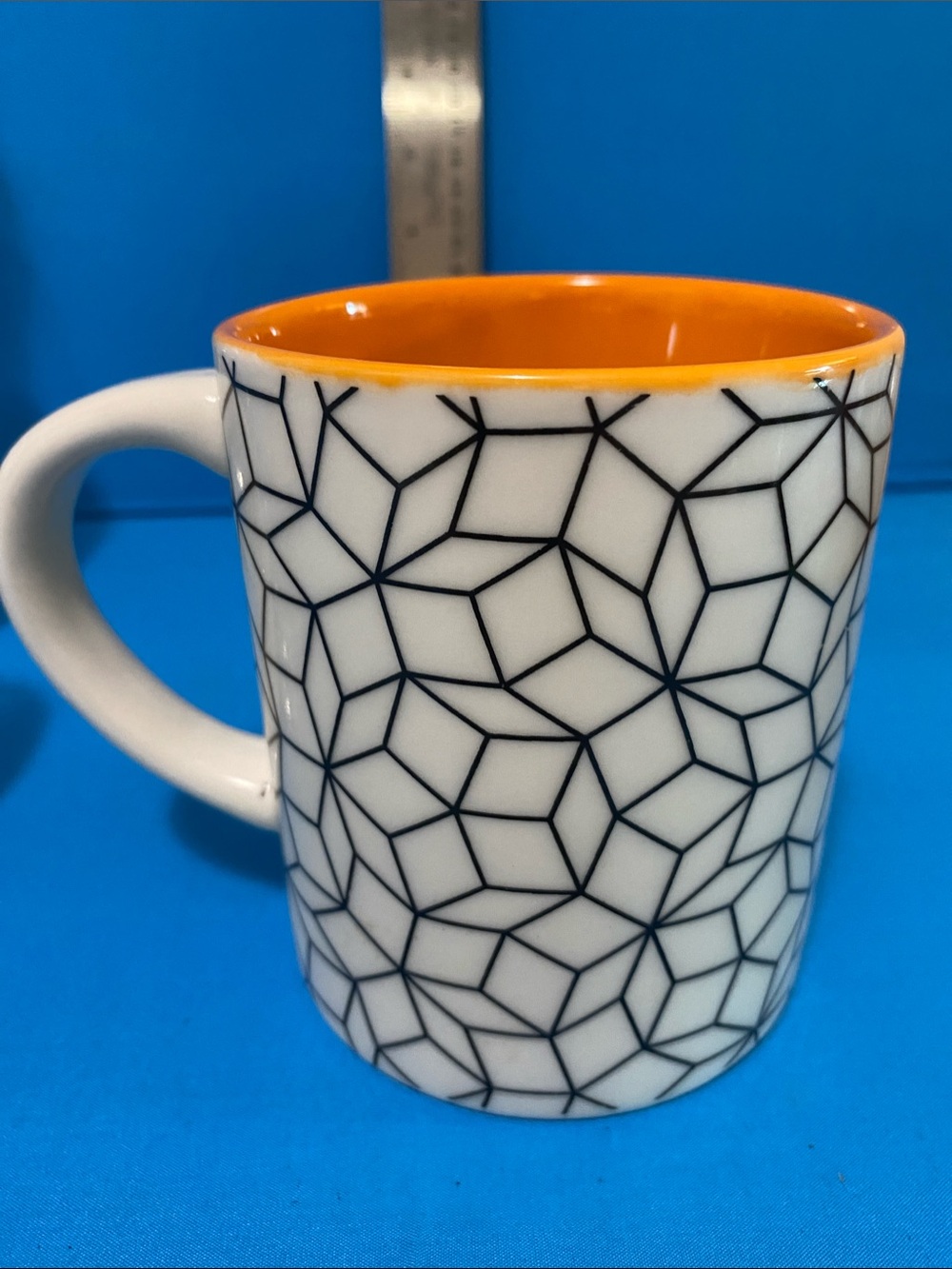 Curiosity Box Mug . Contemporary White Ceramic Mug with Orange Interior